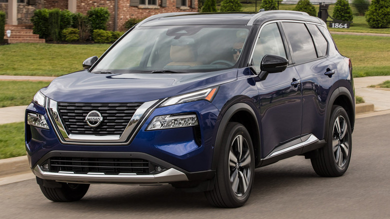 Blue 2021 Nissan Rogue on the road