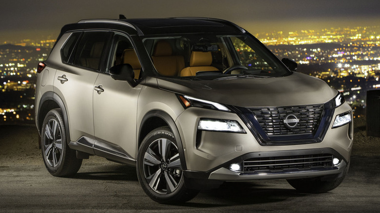 Gold 2022 Nissan Rogue parked at night