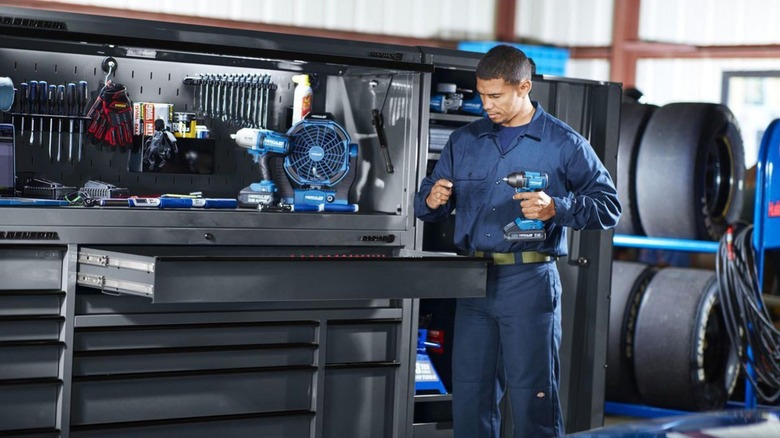 Man pulling tools out of a toolbox