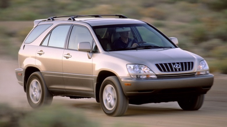 Front 3/4 shot of a 2002 Lexus RX 300 driving on a dirt road