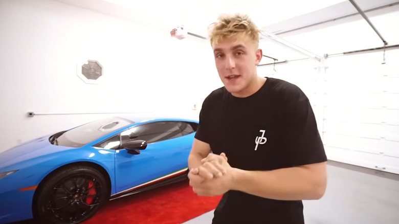 Jake Paul with his blue Lamborghini Huracan Performante in the garage.