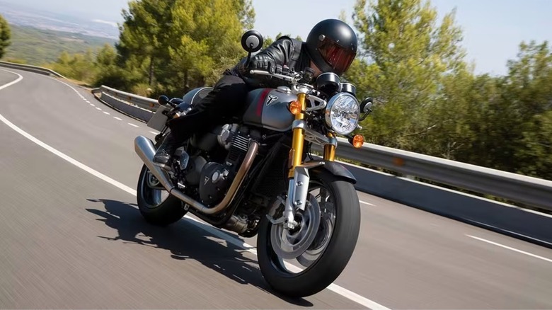 A Triumph Thruxton 1200 RS carving up a mountain road.