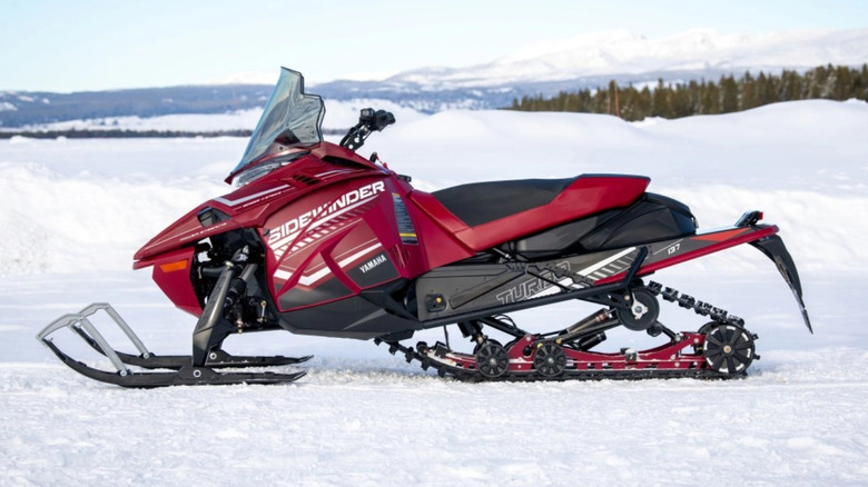 Red Yamaha Sidewinder snowmobile parked in snow