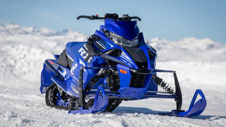 Blue Yamaha Sidewinder snowmobile parked on snow