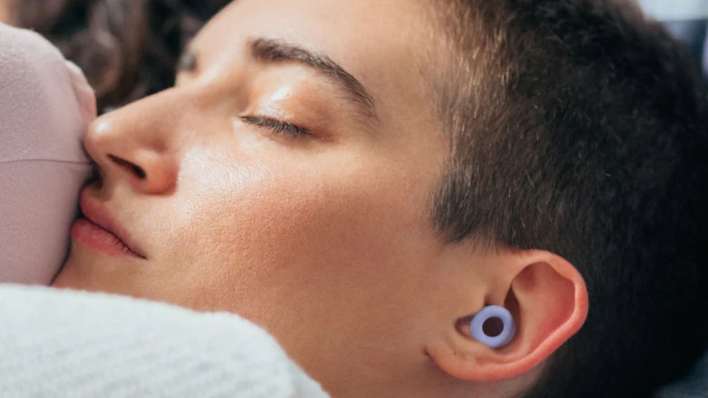 Woman wearing Loop Quiet 2 earplugs to sleep