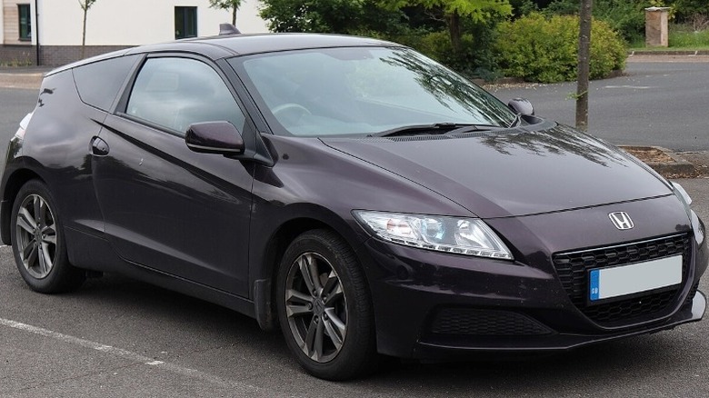 2014 Honda CR-Z parked on a pavement with a building and trees in the background