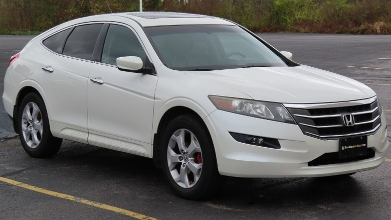 White 2010 Honda Accord Crosstour EX-L 4WD parked on a pavement with trees in the background