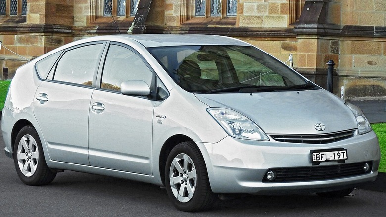 Silver Toyota Prius parked in front of sandstone brick building