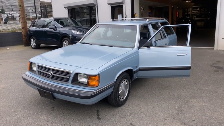 A 1988 Dodge Aries Wagon sits with its door open