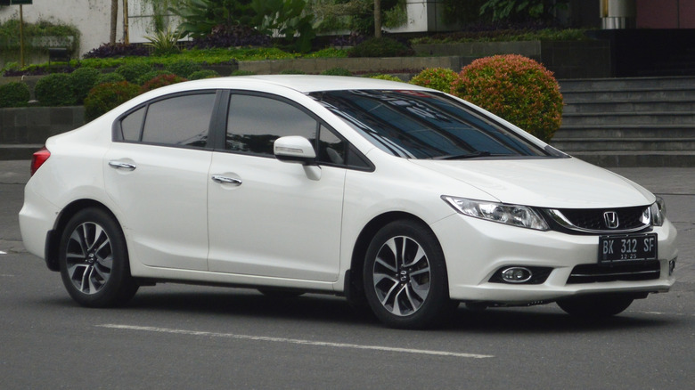 white 2011 Honda Civic on quiet road