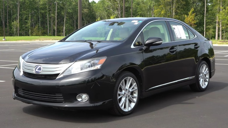 A black 2010 Lexus HS250h is parked in a parking lot.