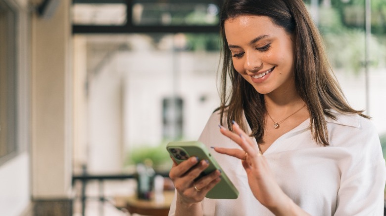 Young businesswoman using apps on cell phones