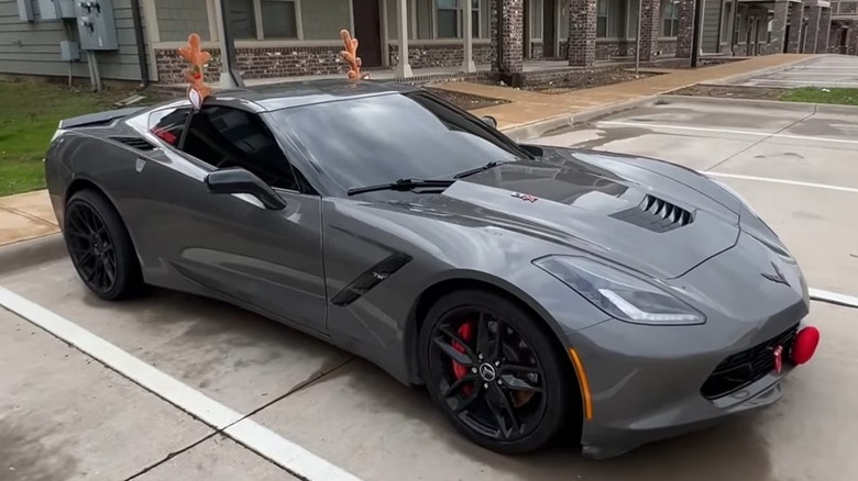 A Corvette with aggressive window tinting in a parking lot