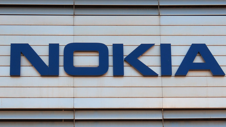 The Nokia logo in blue and on a white wall.