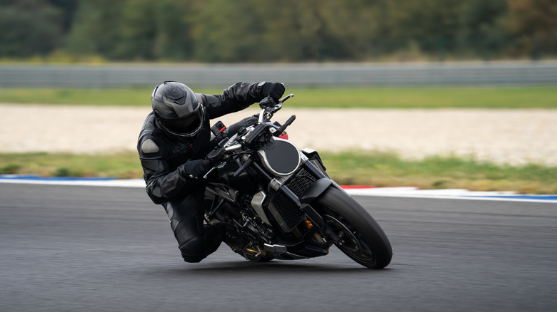 Motorcycle rider riding fast on a motorcycle through a corner