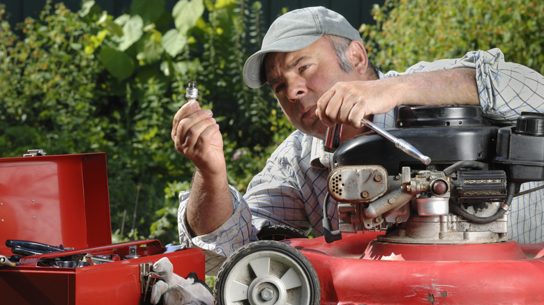 Checking lawn mower spark plug