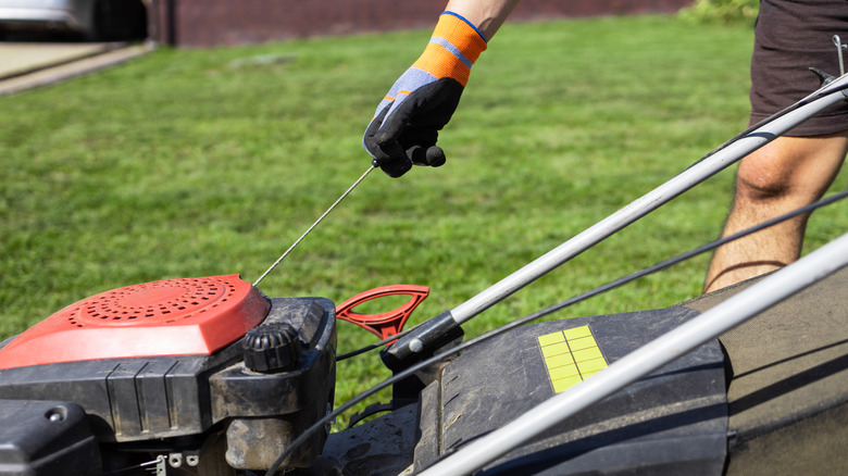 Man starting lawn mower