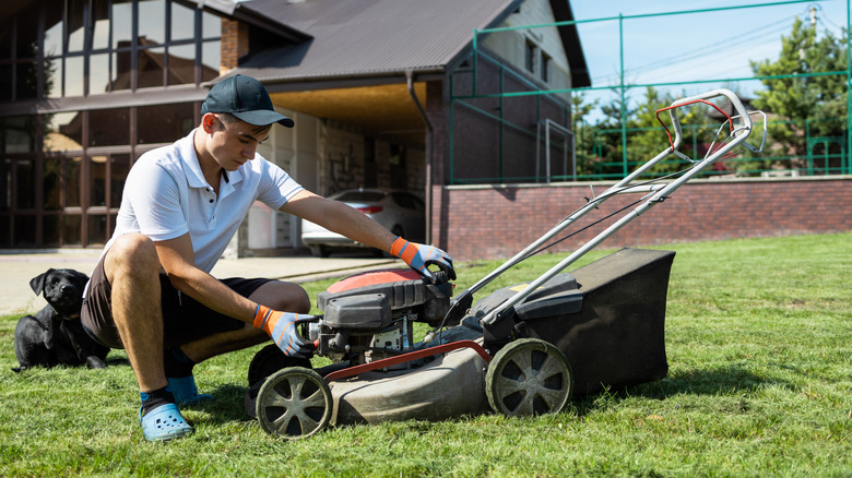 Man working on lawn mower