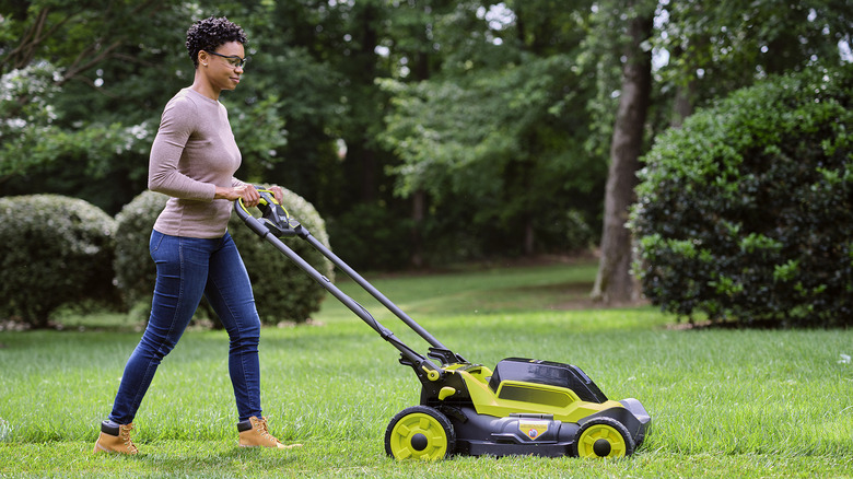 Woman mows her lawn