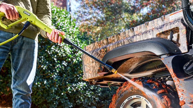 Pressure washing muddy tire