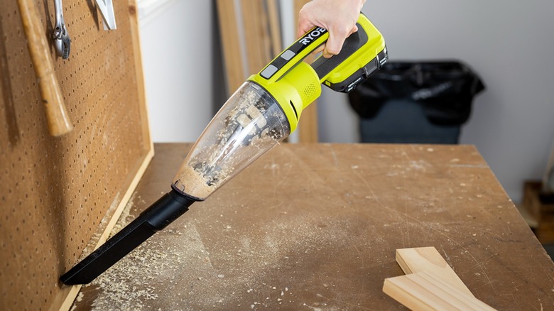 person using ryobi hand vacuum