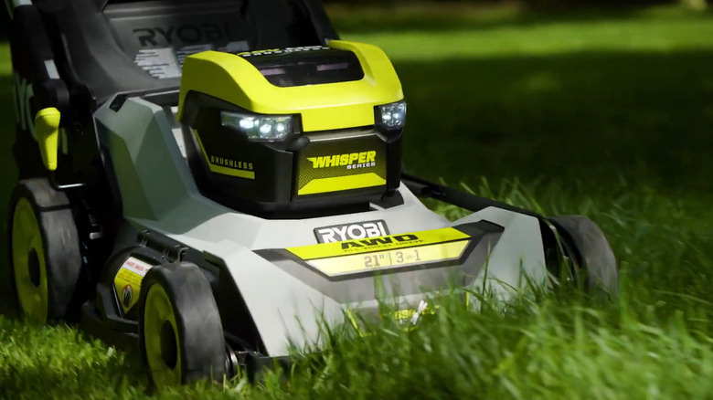 Mower going through grass