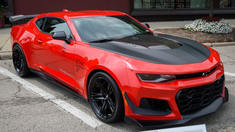 A red 2018 Chevrolet Camaro ZL1 on display at a car show