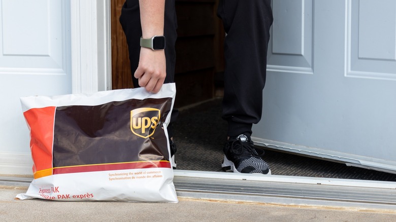 UPS bag outside home being picked up.