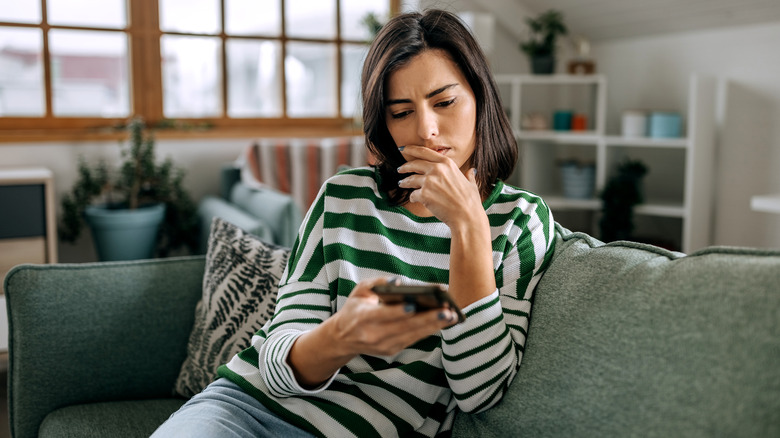 Seated woman using smartphone 