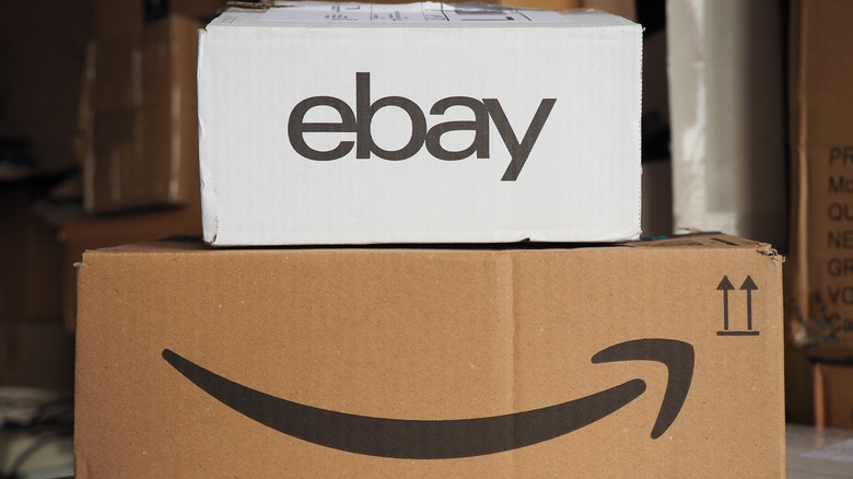 A package with an eBay logo atop one with an Amazon logo