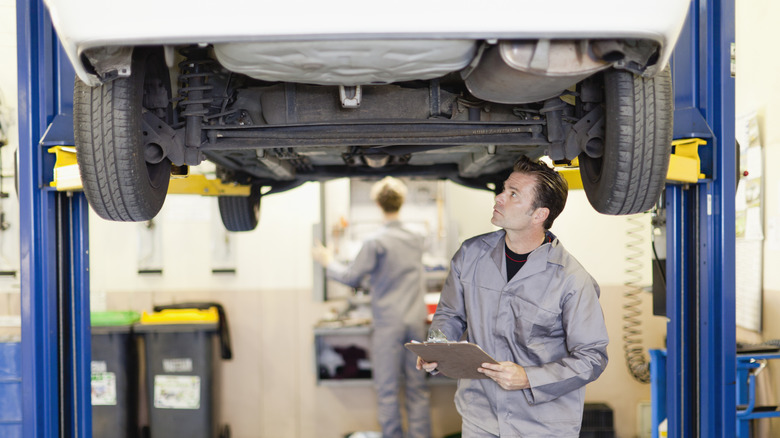 mechanic inspecting vehicle