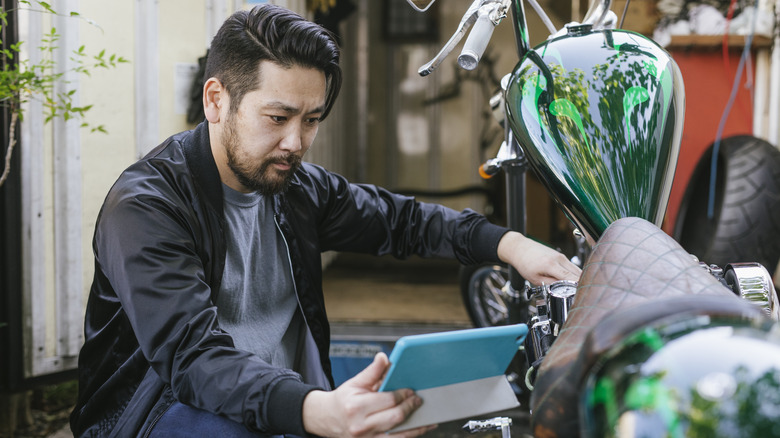 Man inspecting motorcycle