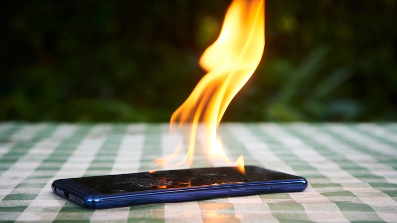 Phone on fire on picnic table