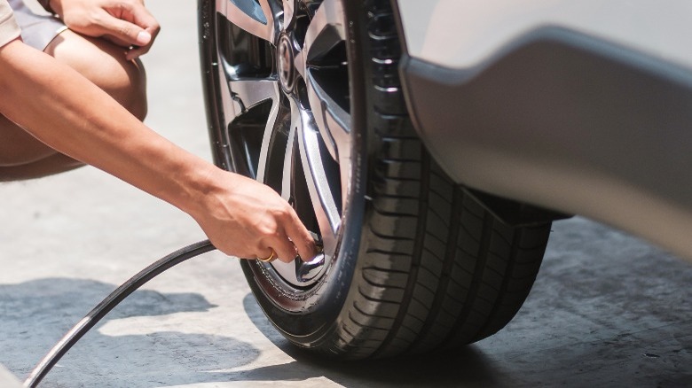 Person filling tire with air