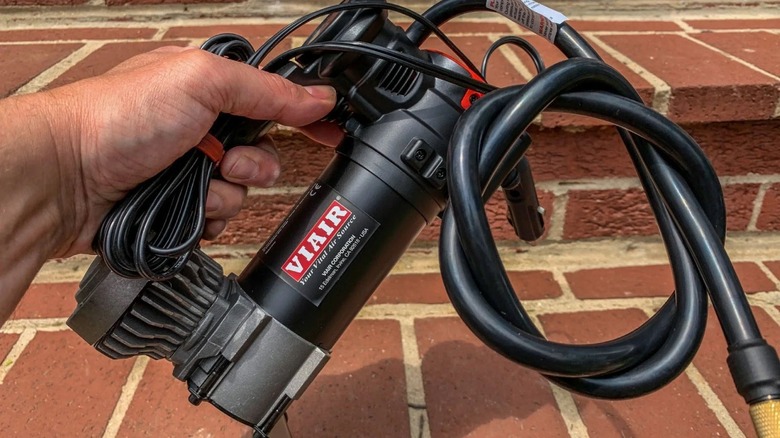 Hand holding portable air compressor