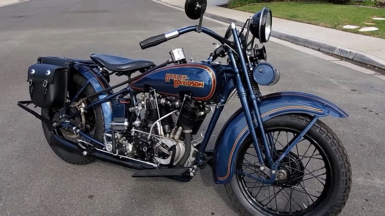 A blue 1925 Harley-Davidson JD parked in the middle of the road