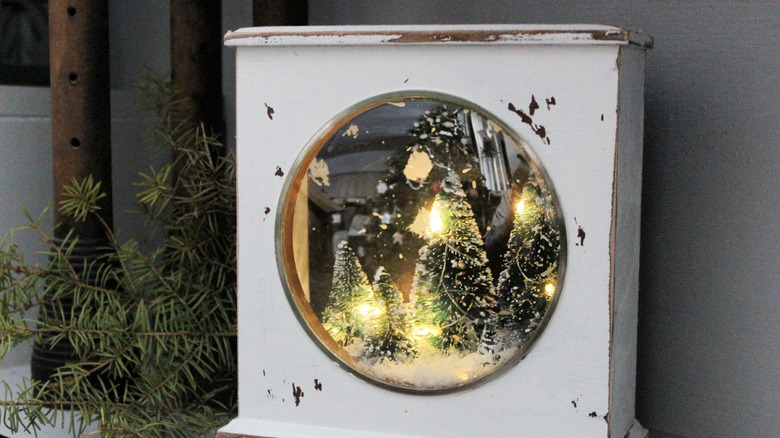 A mantle clock upcycled into a Christmas shadow box.