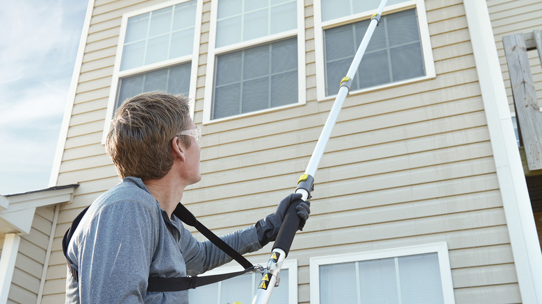 person using ryobi extension pole