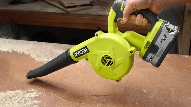 person using ryobi workshop blower