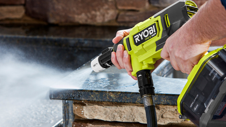 person using ryobi power cleaner