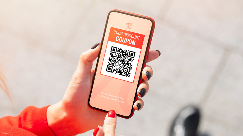 person viewing QR code on smartphone