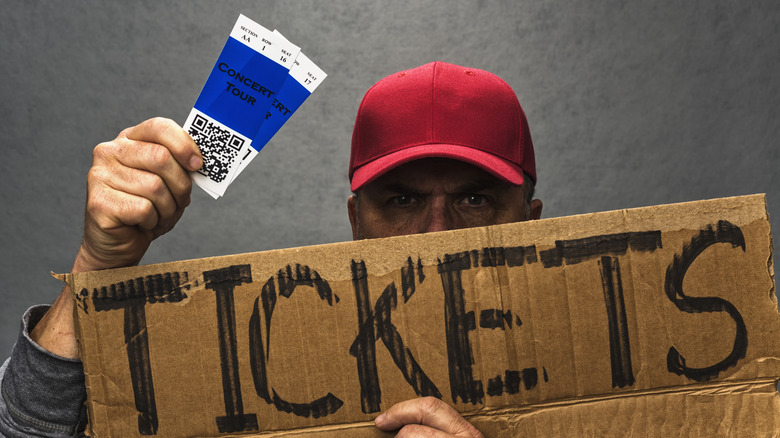 ticket scalper with sign