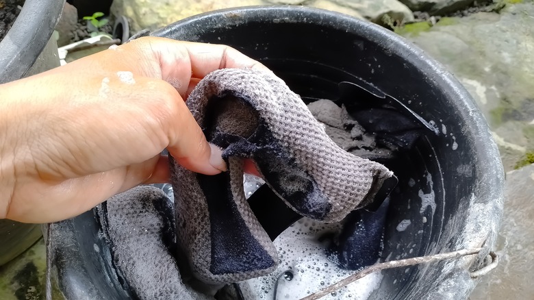 person cleaning inside of helmet