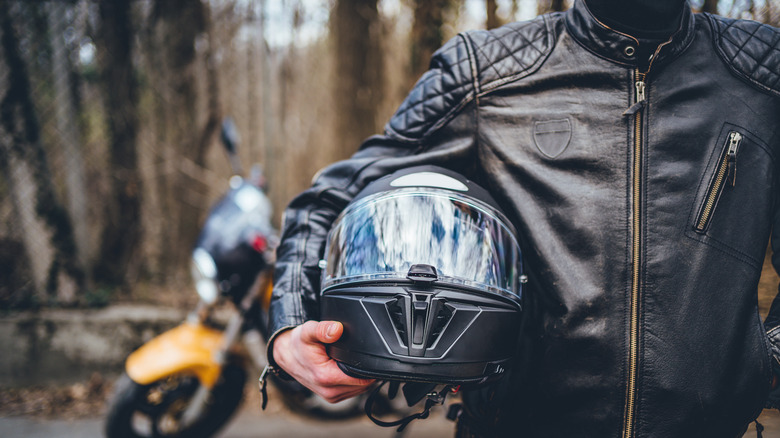 man holding helmet