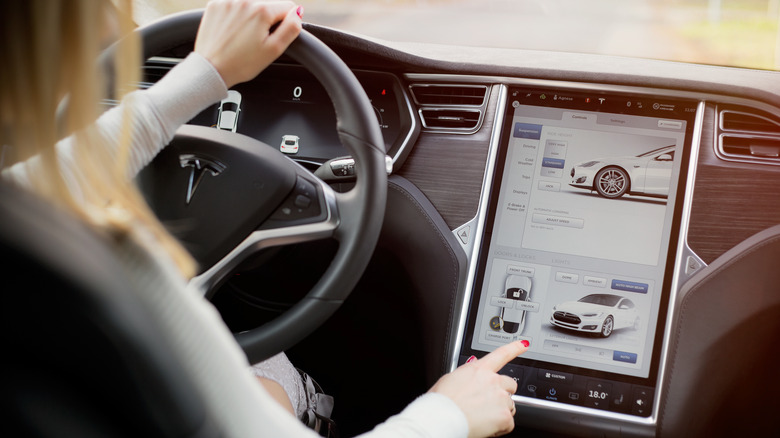 driver operating Tesla's touchscreen