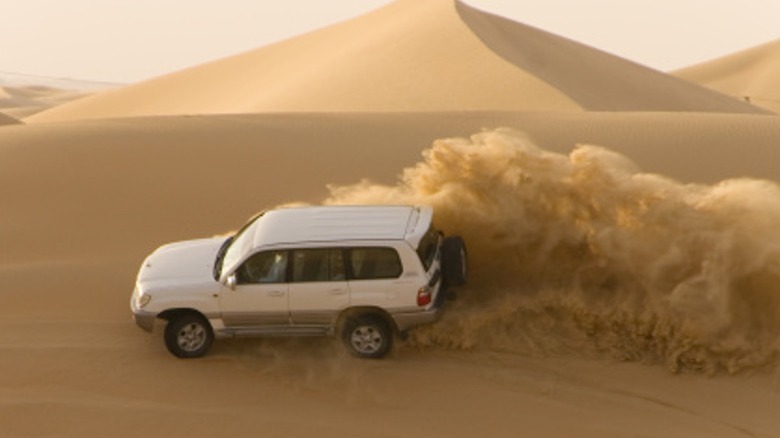 Vehcile driving through sand dunes