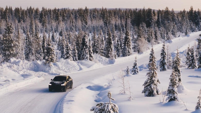 Vehicle driving down snowy road