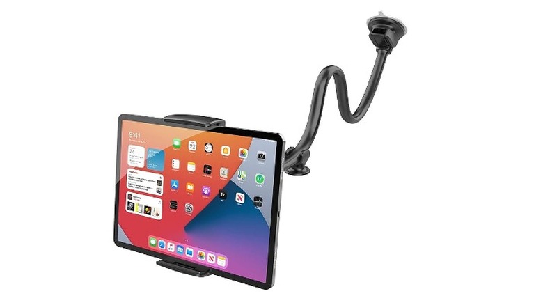 Tablet sitting in car mount with a white background