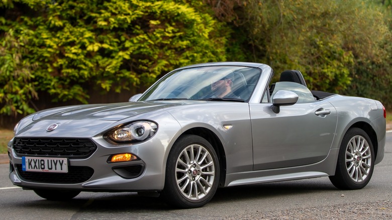 gray Fiat 124 Spider road driving