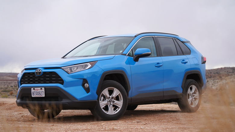 blue Toyota RAV4 parked on dirt road